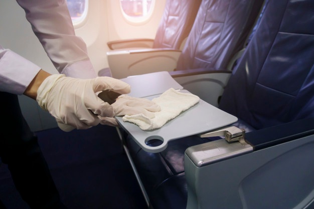 close-up-hand-is-wearing-gloves-cleaning-aircraft-seat-covid-19-prevention-pandemic_33799-8406